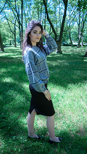 model in grey shirt and black skirt